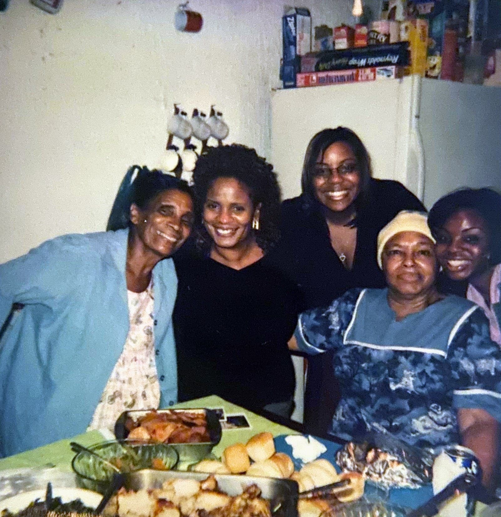Josephine Smith, Evelyn Stephens, Betty Tanner Thomas, Josie Smith and Evelyn Volter gathered around a table of food in the kitchen of the Sunnyside family home.